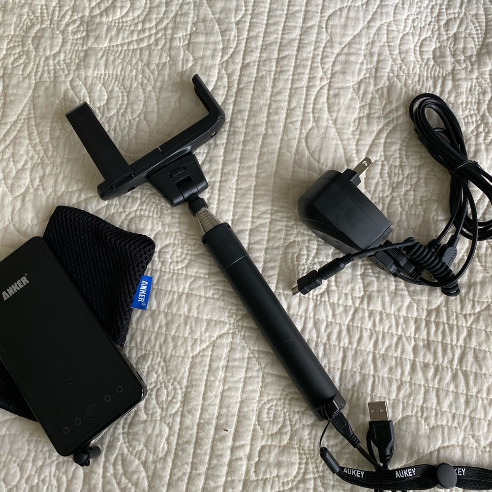 Anker battery charger for mobile device, selfie stick and travel charger.